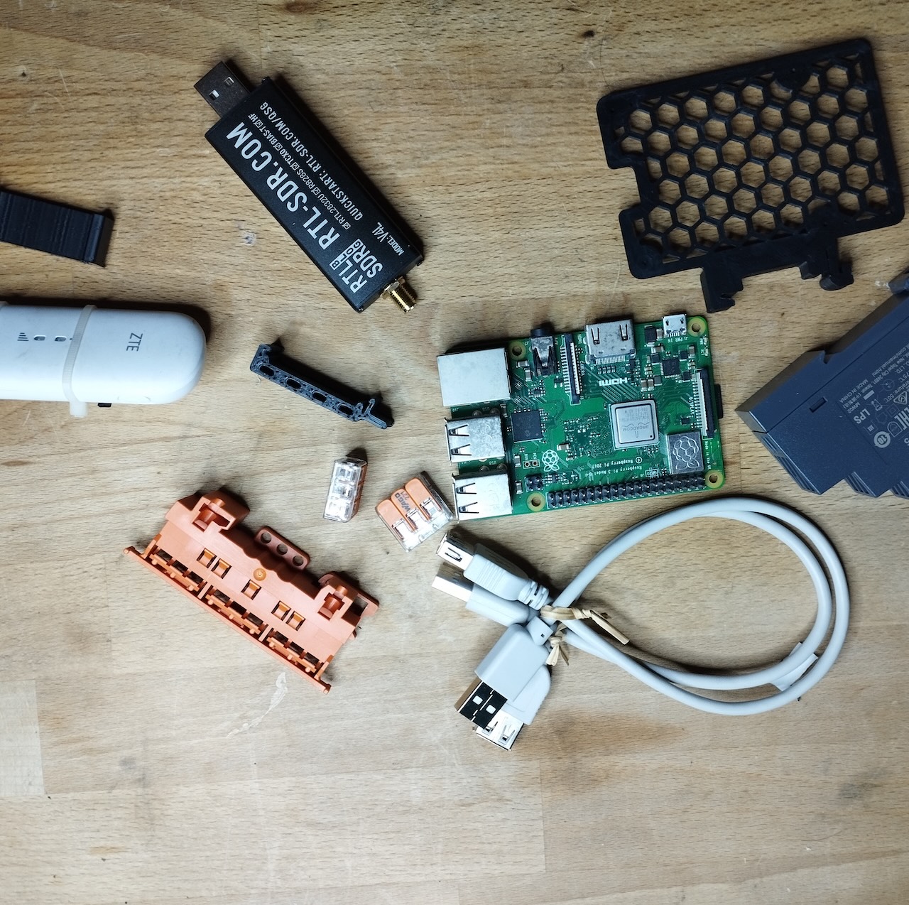 All hardware laid out: Raspberry Pi, RTL-SDR dongle, LTE modem